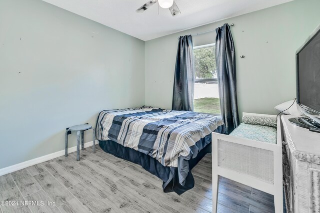 bedroom with ceiling fan and light hardwood / wood-style flooring