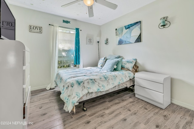 bedroom with ceiling fan and wood-type flooring