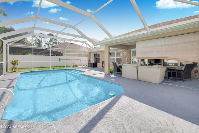 view of swimming pool featuring a patio and glass enclosure