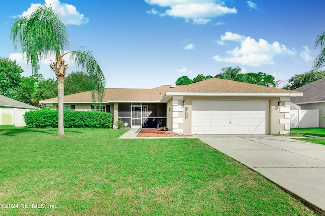 single story home featuring a garage and a front yard