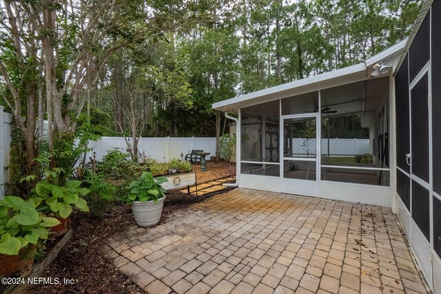 view of patio featuring a sunroom