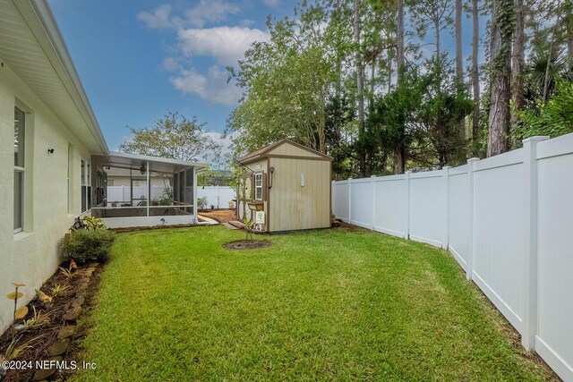 view of yard featuring a storage unit and a sunroom