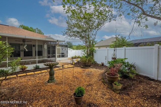 view of yard with ceiling fan and a patio area