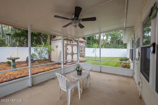 sunroom featuring ceiling fan and plenty of natural light