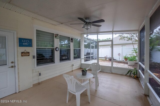 sunroom / solarium featuring ceiling fan and plenty of natural light