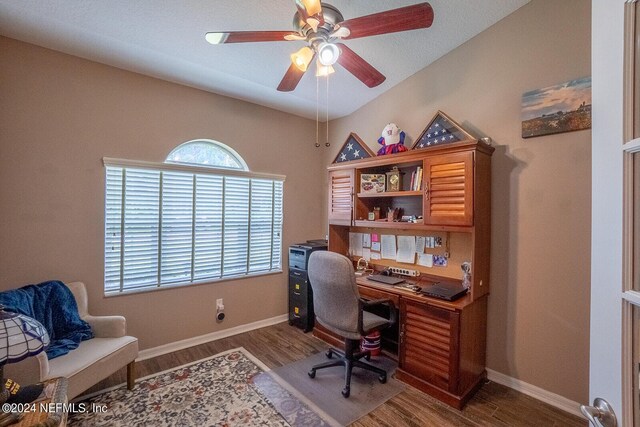 home office with ceiling fan and dark hardwood / wood-style floors