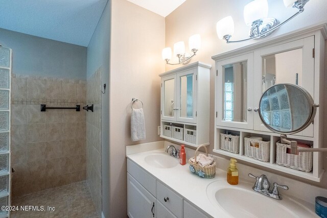 bathroom featuring vanity and a tile shower