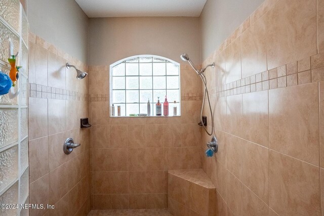 bathroom with tiled shower