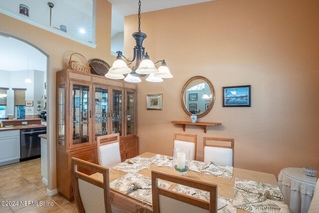 dining space featuring light tile patterned floors and a notable chandelier