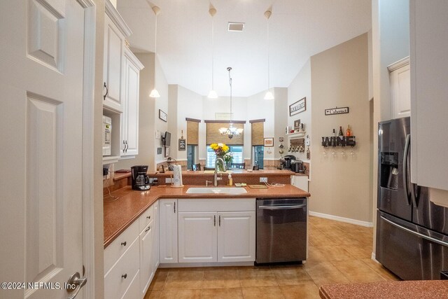 kitchen featuring stainless steel appliances, white cabinets, kitchen peninsula, and sink