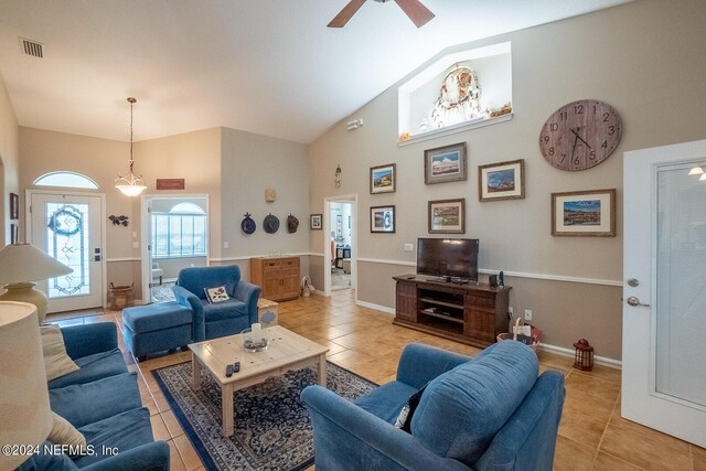 living room with high vaulted ceiling, ceiling fan, and light tile patterned floors