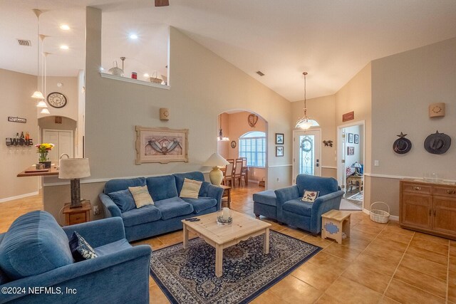 tiled living room with high vaulted ceiling