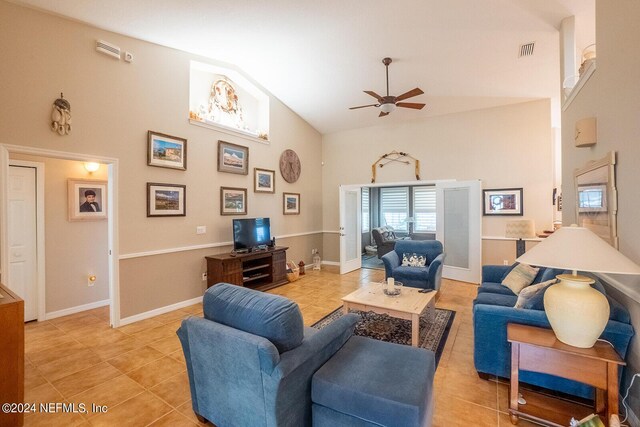 living room with light tile patterned floors, ceiling fan, and high vaulted ceiling