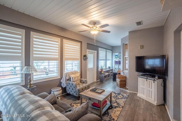 living room with ceiling fan and dark hardwood / wood-style floors