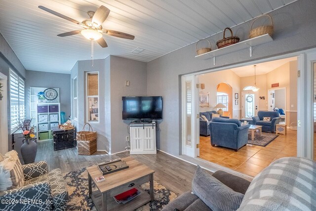 living room with wood ceiling, ceiling fan, and light hardwood / wood-style flooring