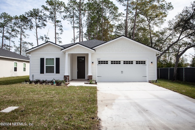 view of front of house featuring a garage and a front yard