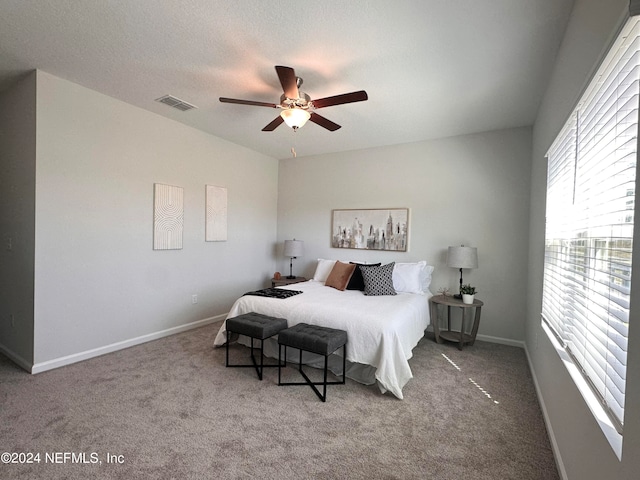 bedroom featuring a textured ceiling, carpet, and ceiling fan