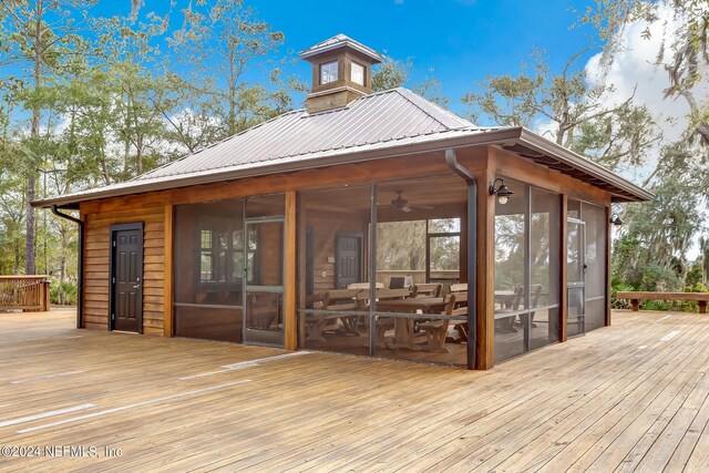 wooden deck featuring a sunroom