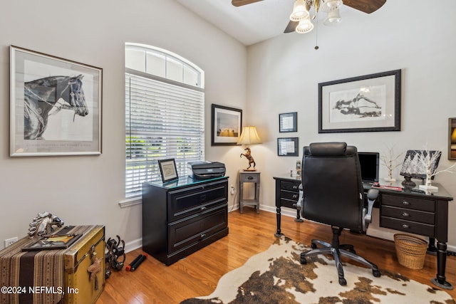 home office featuring light wood-type flooring and ceiling fan