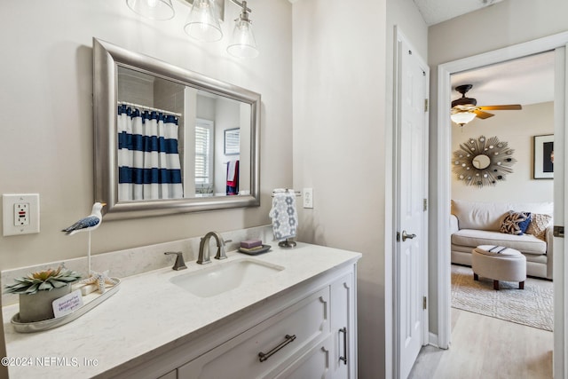 bathroom with ceiling fan, vanity, and hardwood / wood-style floors