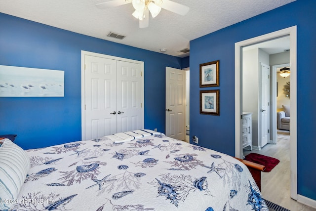 bedroom with a closet, ceiling fan, and a textured ceiling