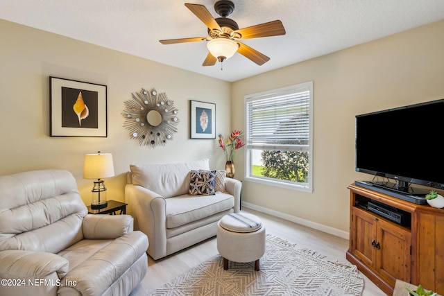 living room featuring light wood-type flooring and ceiling fan