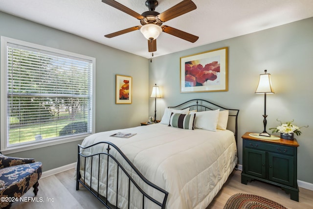 bedroom featuring ceiling fan and light hardwood / wood-style floors