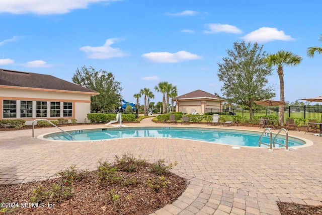 view of swimming pool with a patio