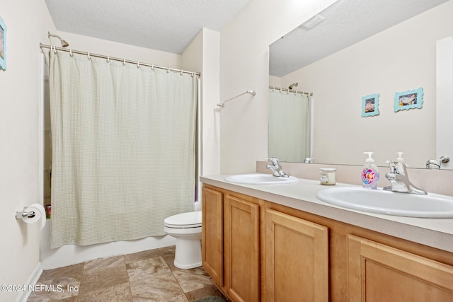 full bathroom with vanity, shower / tub combo, a textured ceiling, and toilet