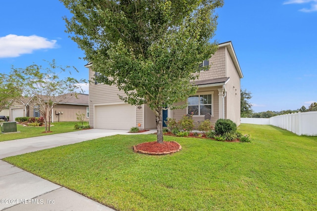 view of front of property featuring a garage and a front yard