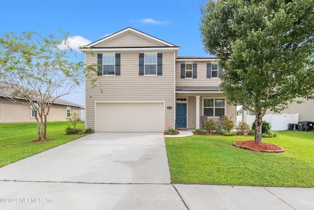 view of front of home with a garage and a front yard