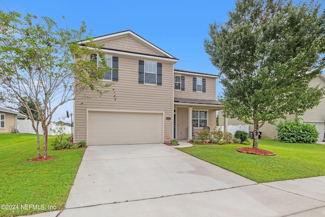 view of property featuring a garage and a front yard