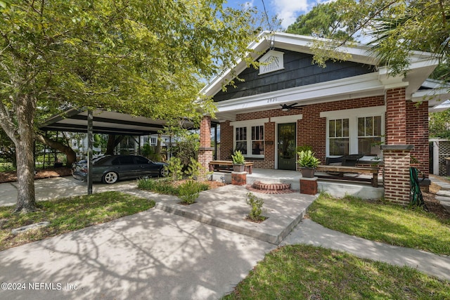 view of front of house with a carport, ceiling fan, and a porch