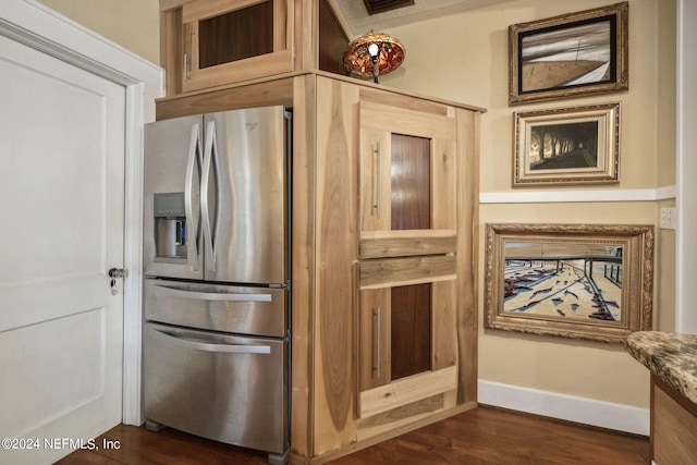 kitchen featuring dark hardwood / wood-style flooring and stainless steel refrigerator with ice dispenser