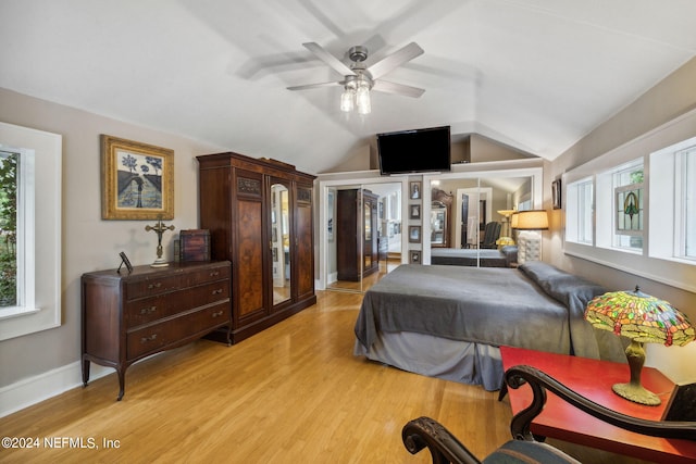 bedroom featuring french doors, light hardwood / wood-style flooring, ceiling fan, and lofted ceiling