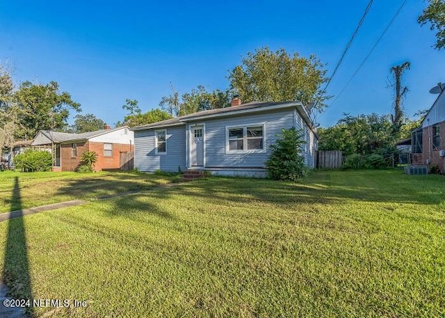 view of front of property featuring a front lawn and central air condition unit