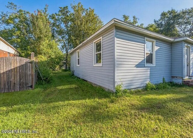 view of home's exterior with a lawn