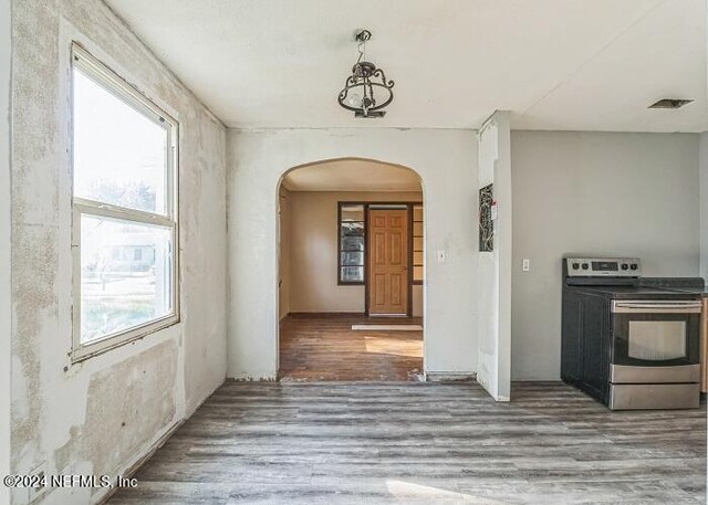 kitchen featuring stainless steel electric range oven and hardwood / wood-style floors