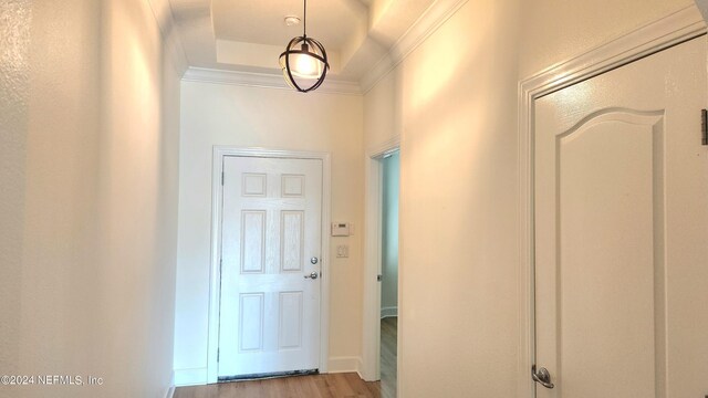 entrance foyer featuring ornamental molding and light hardwood / wood-style flooring