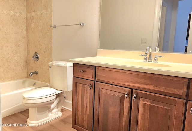 full bathroom with tiled shower / bath combo, vanity, toilet, and hardwood / wood-style flooring