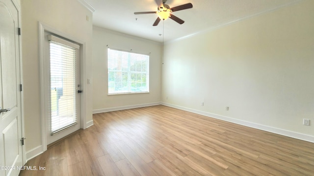 empty room with crown molding, ceiling fan, and light hardwood / wood-style flooring