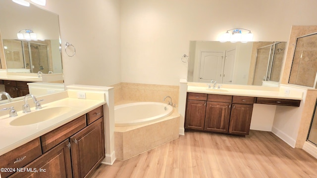 bathroom featuring vanity, separate shower and tub, and hardwood / wood-style flooring