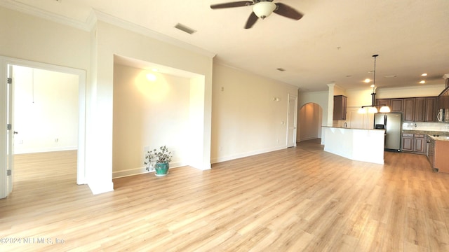 unfurnished living room featuring light hardwood / wood-style floors, ceiling fan, and crown molding