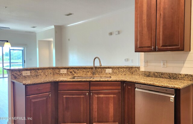 kitchen with dishwasher, light stone counters, sink, kitchen peninsula, and decorative backsplash