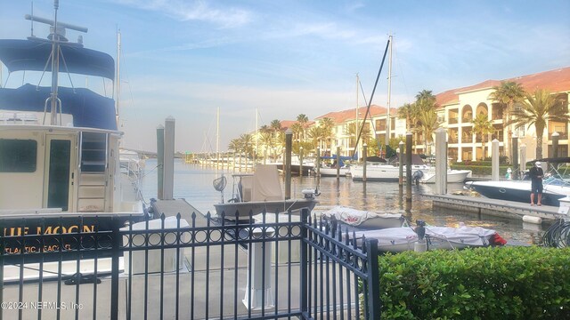 view of community featuring a dock and a water view