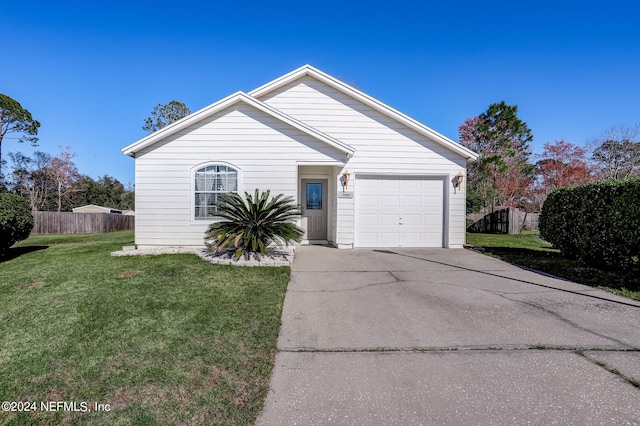 view of front of property with a front yard and a garage