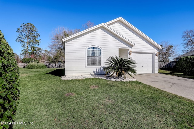 view of front of home featuring a front lawn and a garage