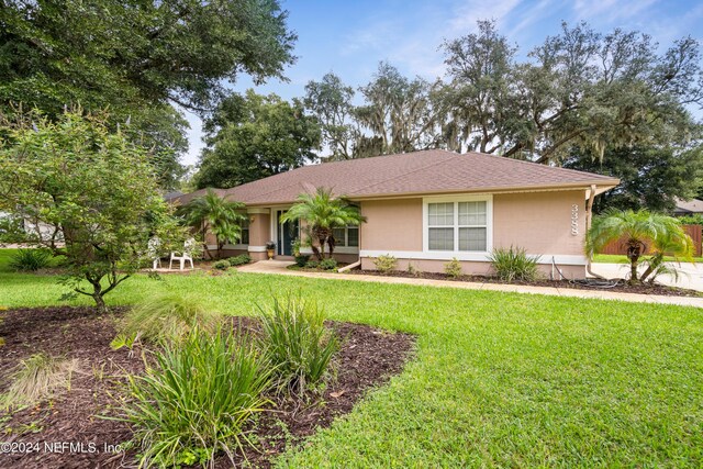 ranch-style home featuring a front yard