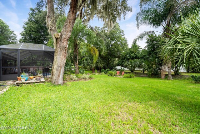 view of yard with a lanai