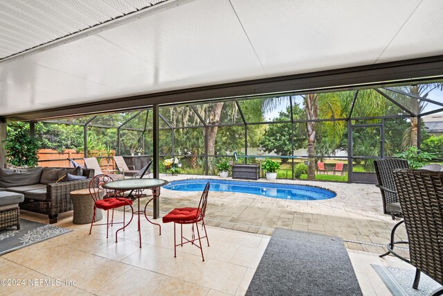 view of pool featuring a jacuzzi, glass enclosure, and a patio